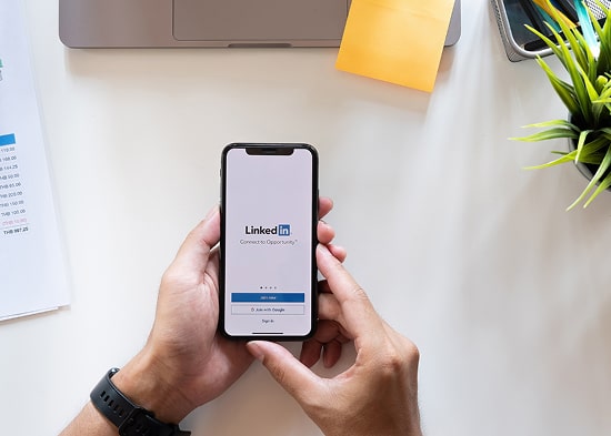 Person holding phone with LinkedIn on the screen