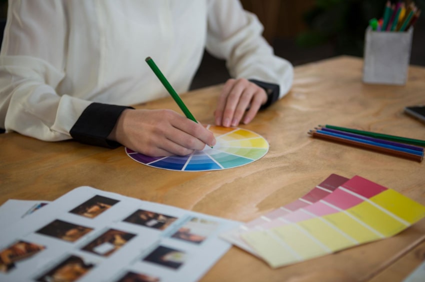 A person using a color wheel to select a color for branding purposes. A person using a color wheel to select a color for branding purposes.